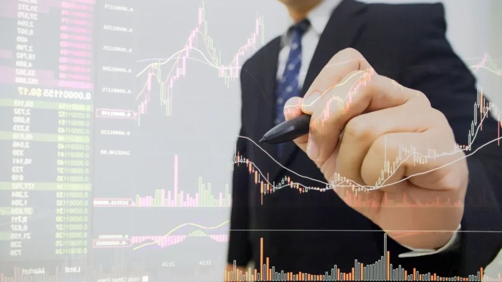 wClose-up of a person in professional attire interacting with a transparent screen displaying real-time trading graphs, candlestick charts, and market analytics.
