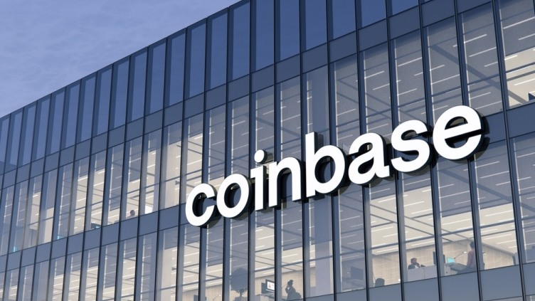 Coinbase logo displayed on the exterior of a modern glass office building