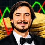 Robinhood CEO Vlad Tenev Says, “The Future in Crypto Is in Real-World Assets.” Robinhood CEO Vlad Tenev in front of stacked gold Bitcoin coins, with red and green market trend lines and upward-pointing arrows in the background.