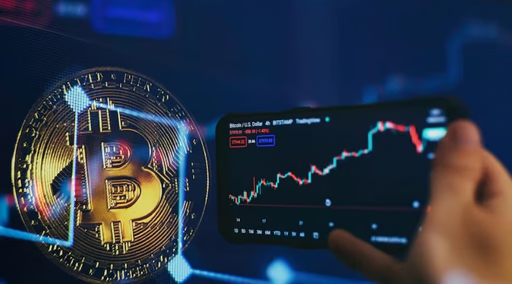 Bitcoin coin beside a smartphone displaying a cryptocurrency price chart and market trading data.