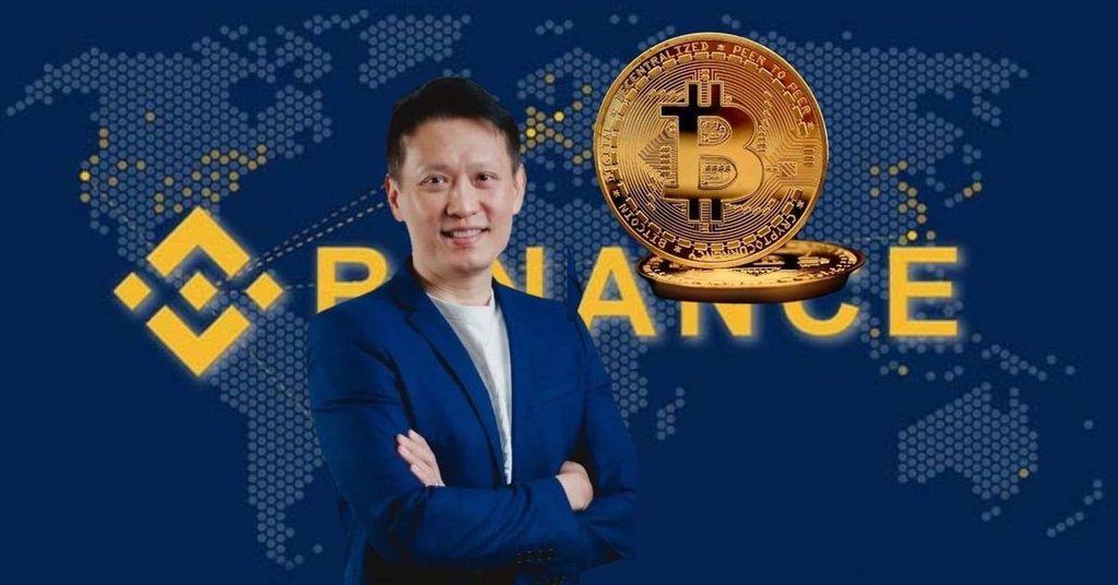 Image of Richard Teng wearing a blue suit and a white shirt with the Binance logo and BTC coin in the background