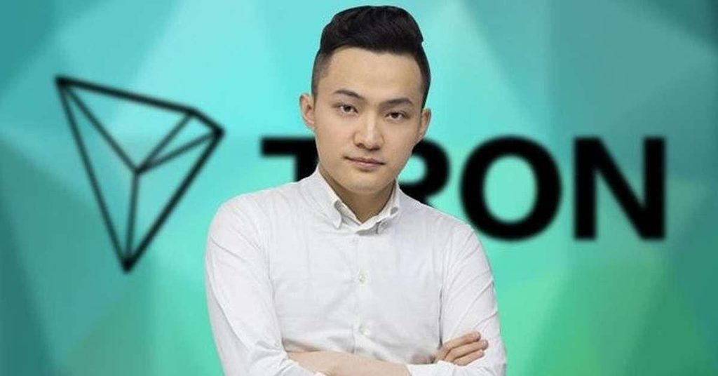 image of Justin Sun wearing white shirt with the tron label in the background