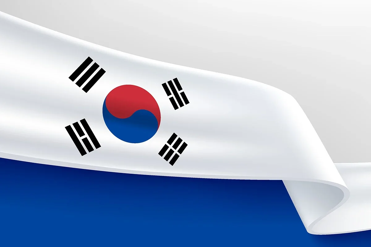 South Korean flag waving against a clean white and blue background.