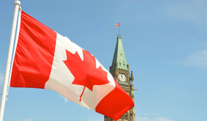 Canadian flag waving with the Peace Tower 
